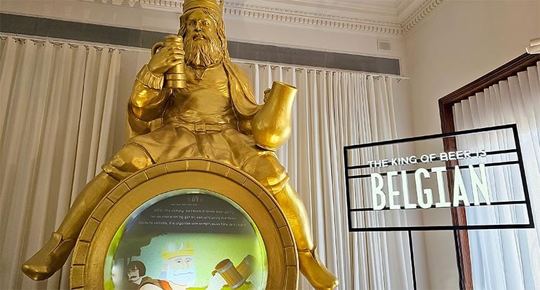 King Gambrinus, the legendary king of beer, sitting atop a hefty gilded beer barrel installation at Belgian Beer World.