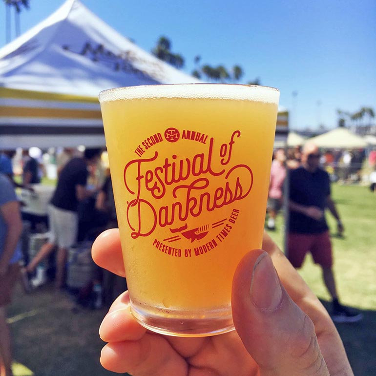 festival of dankness glass in festivalgoer's hand