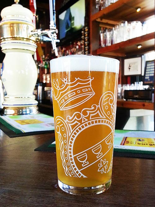 Sünner Brauerei kellerbier glass sits atop a bar