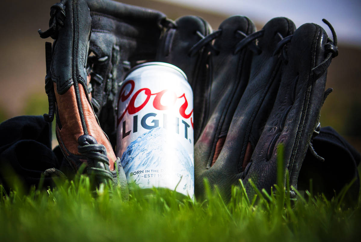 coors light can in a baseball glove