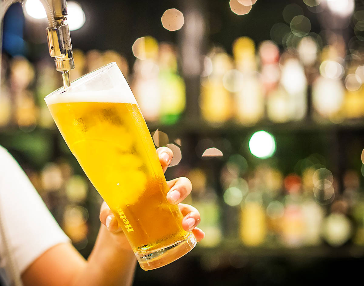 light lager being poured from a tap in a bar