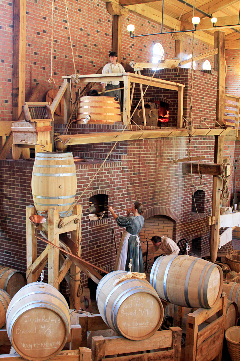 Volunteers in period costumes work the kettles, while others churn butter or tend the fireplaces. The walls are exposed brick and wood, and all of the hardware, down to every visible nail, authenticates the experience.