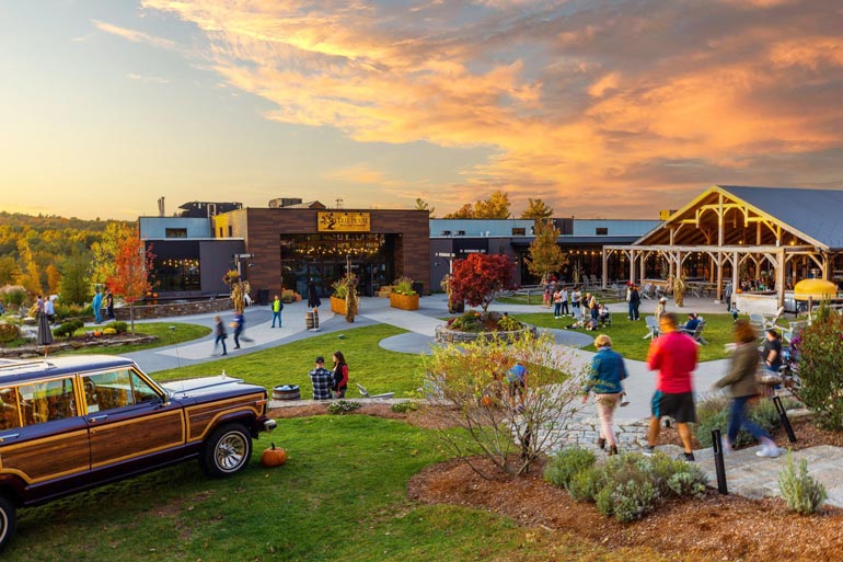 charlton treehouse brewing exterior at sunset with people filing in and hanging out on patio