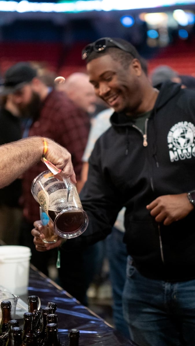 man enjoying dark barrel-aged beer at fobab 2024