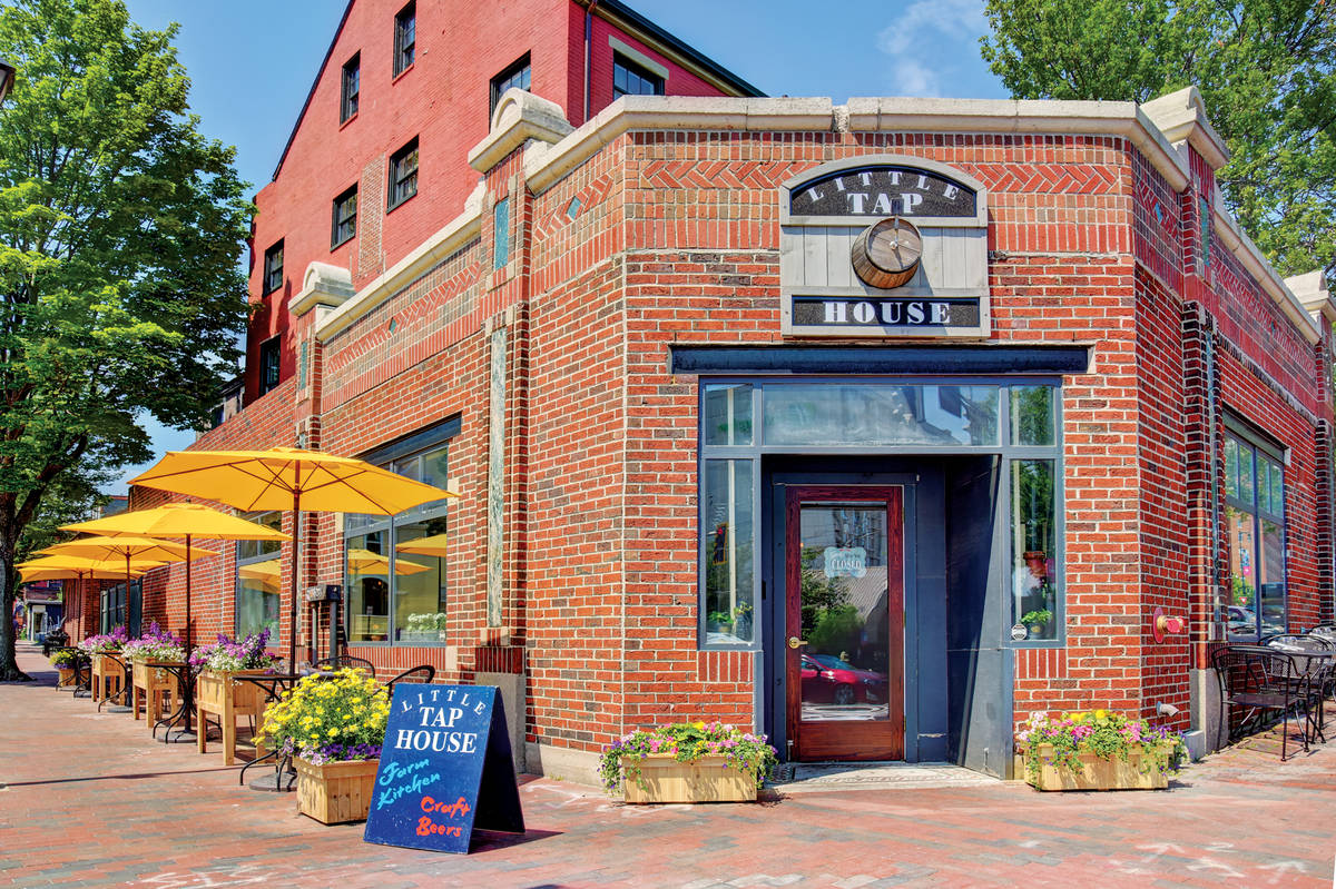 little tap house exterior with outdoor tables