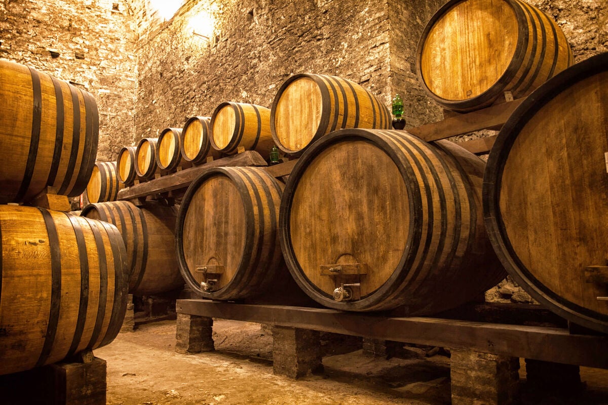 collection of whiskey barrels aging whiskey